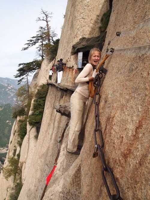 woman walking on dangerous cliff