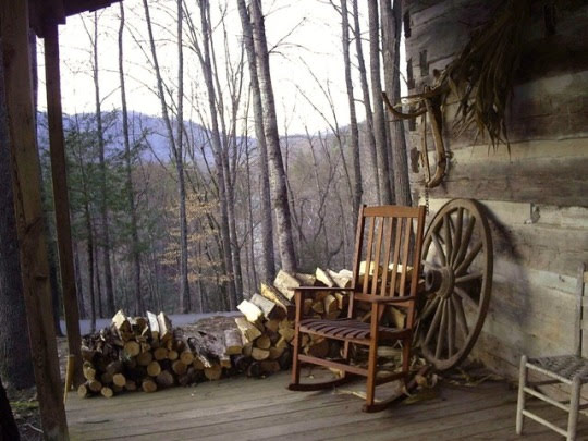 old porch with rocking chair and firewood