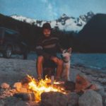 a man a dog and a campfire
