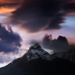 colorful clouds and snow capped mountain