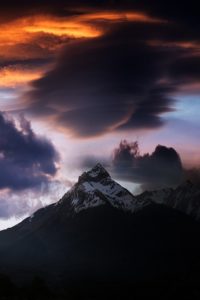 colorful clouds and snow capped mountain