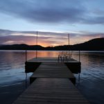 dock on a lake at sunset
