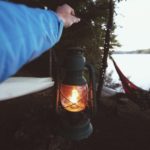 lantern at campsite by lake