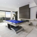 modern room with guitars and pool table