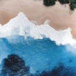 overhead shot of blue water and beach