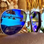 sunglasses reflecting beach scene