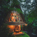 tiki hut style cabin by a river