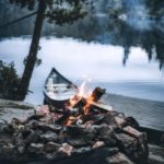 campfire and boat by a dock
