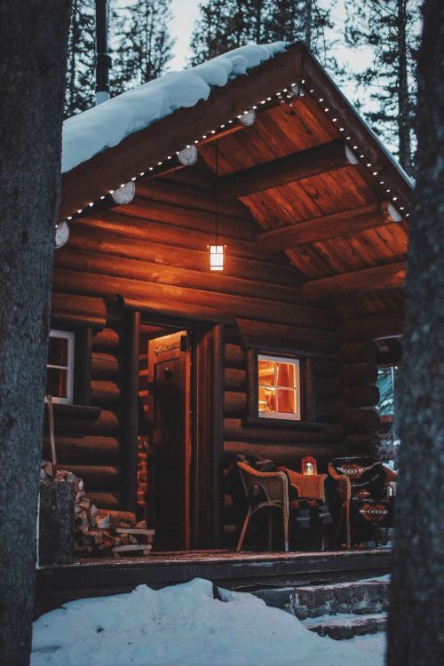 dark wood cabin in snow