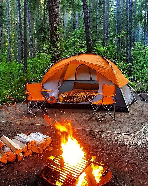 orange tent next to campfire