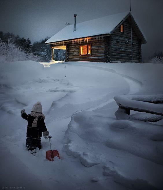 child sledding outside of cabin