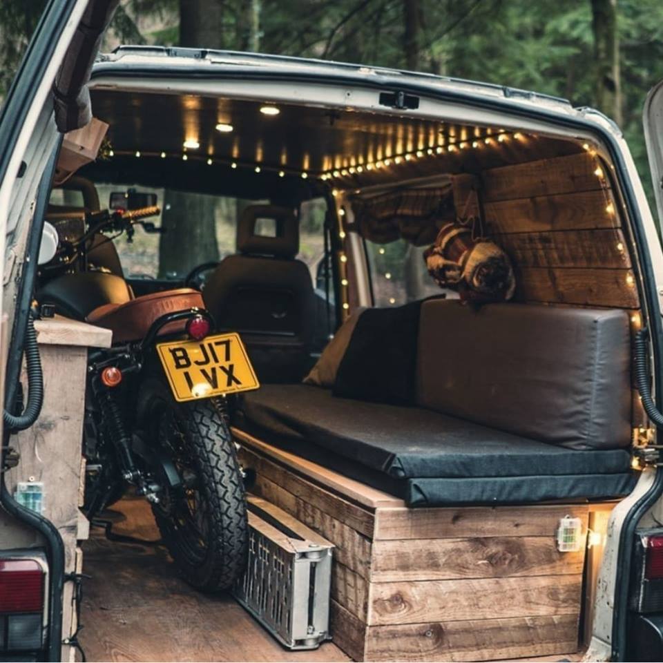 camper van with motorcycle in back