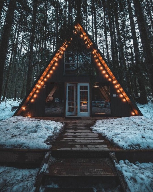 a frame cabin with lights