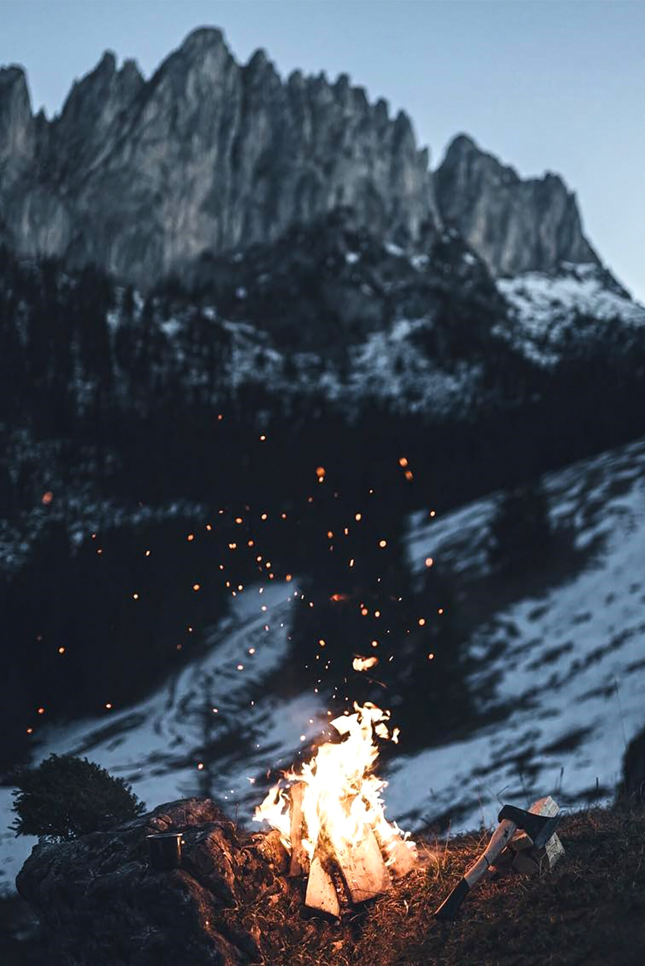 mountain snow scene with campfire