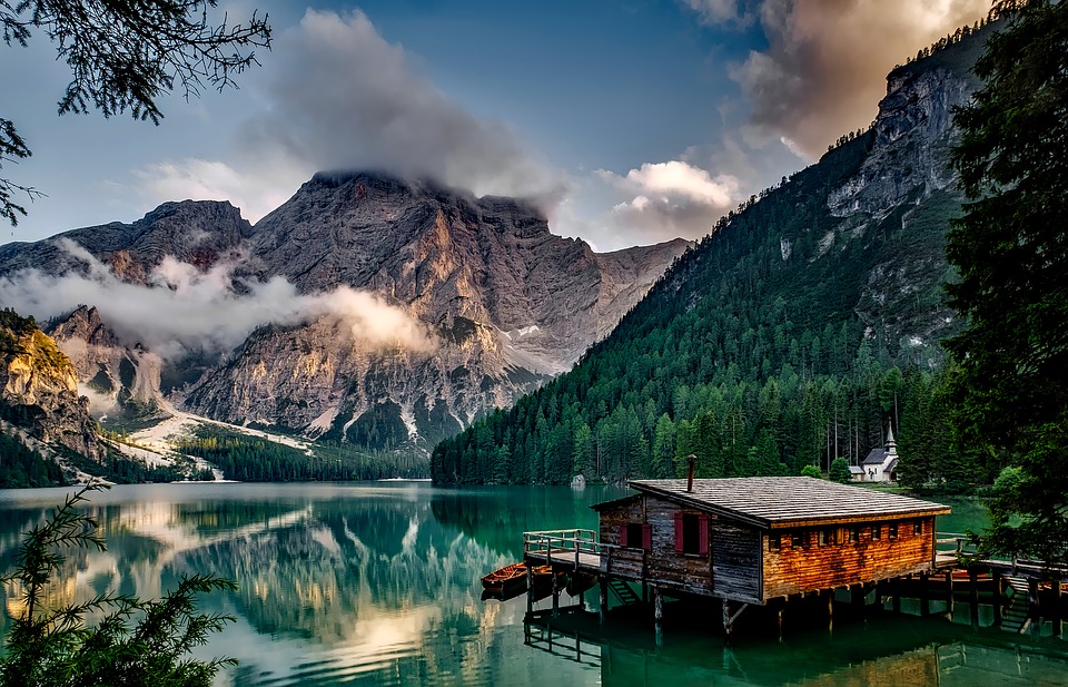 calm mountain lake and cabin