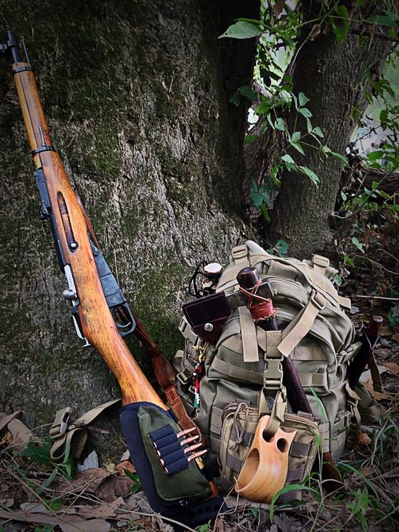 survival gear with backpack ax and rifle