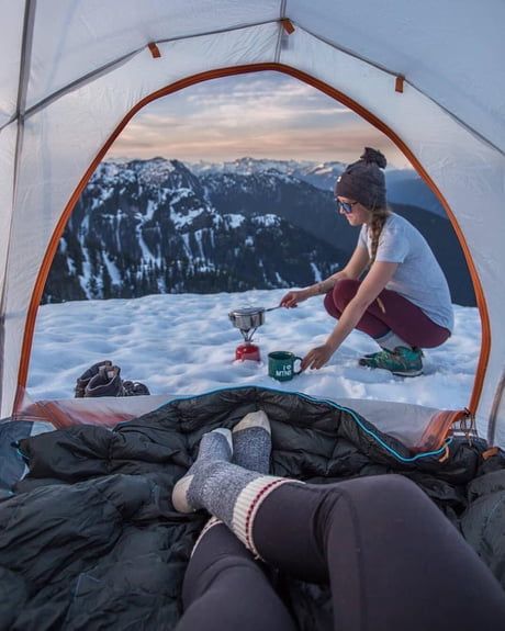 couple camping on snow covered mountain
