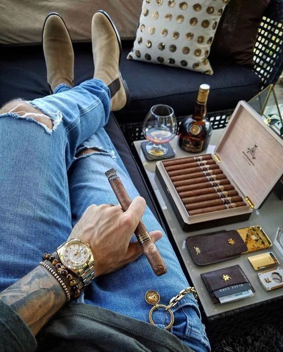 man relaxing with cigars
