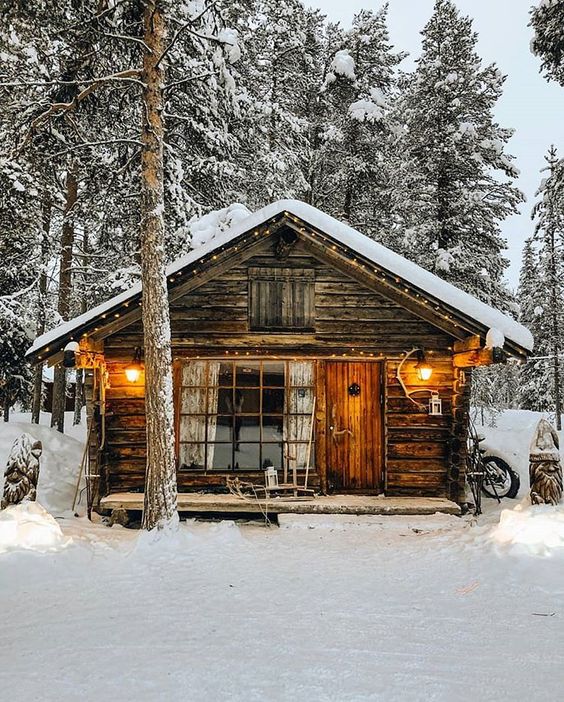 rustic cabin in the woods with snow
