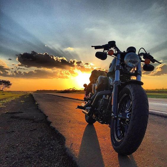 a motorcycle and a sunset