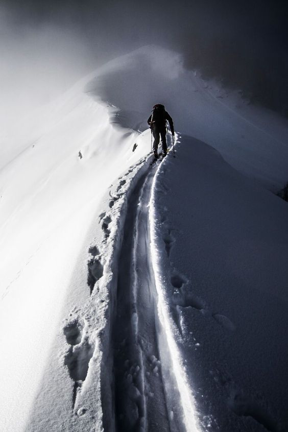 mountain climber trekking through snow