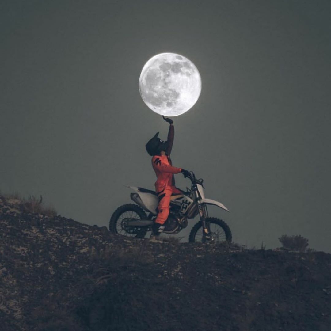 motorcycle rider holding up moon