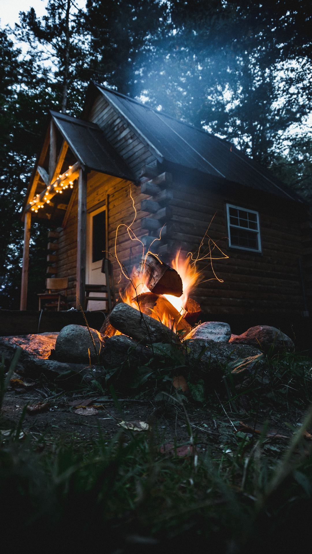 campfire outside of cabin