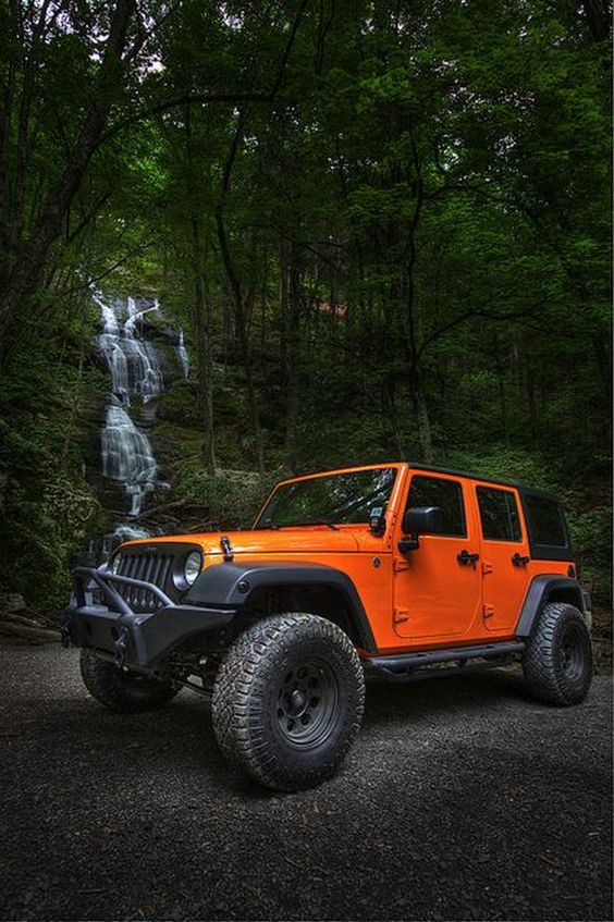 jeep next to waterfall