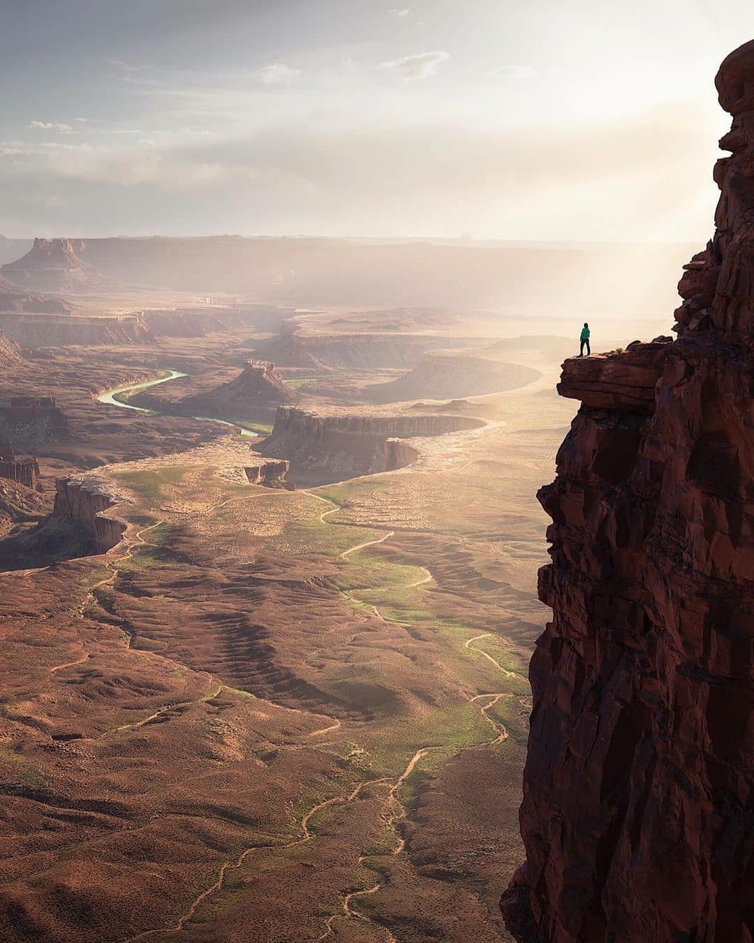 man standing on cliff in Utah