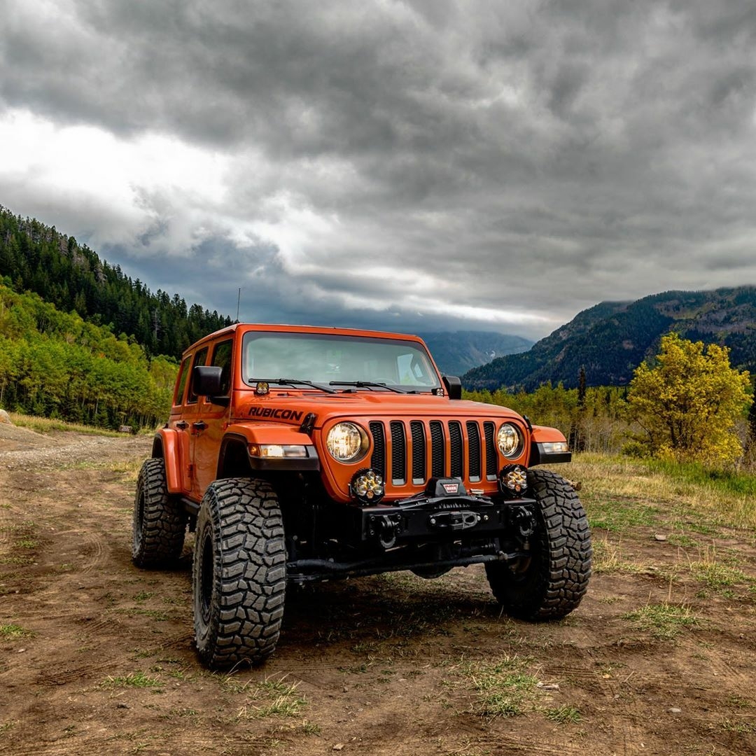 orange jeep rubicon in the country