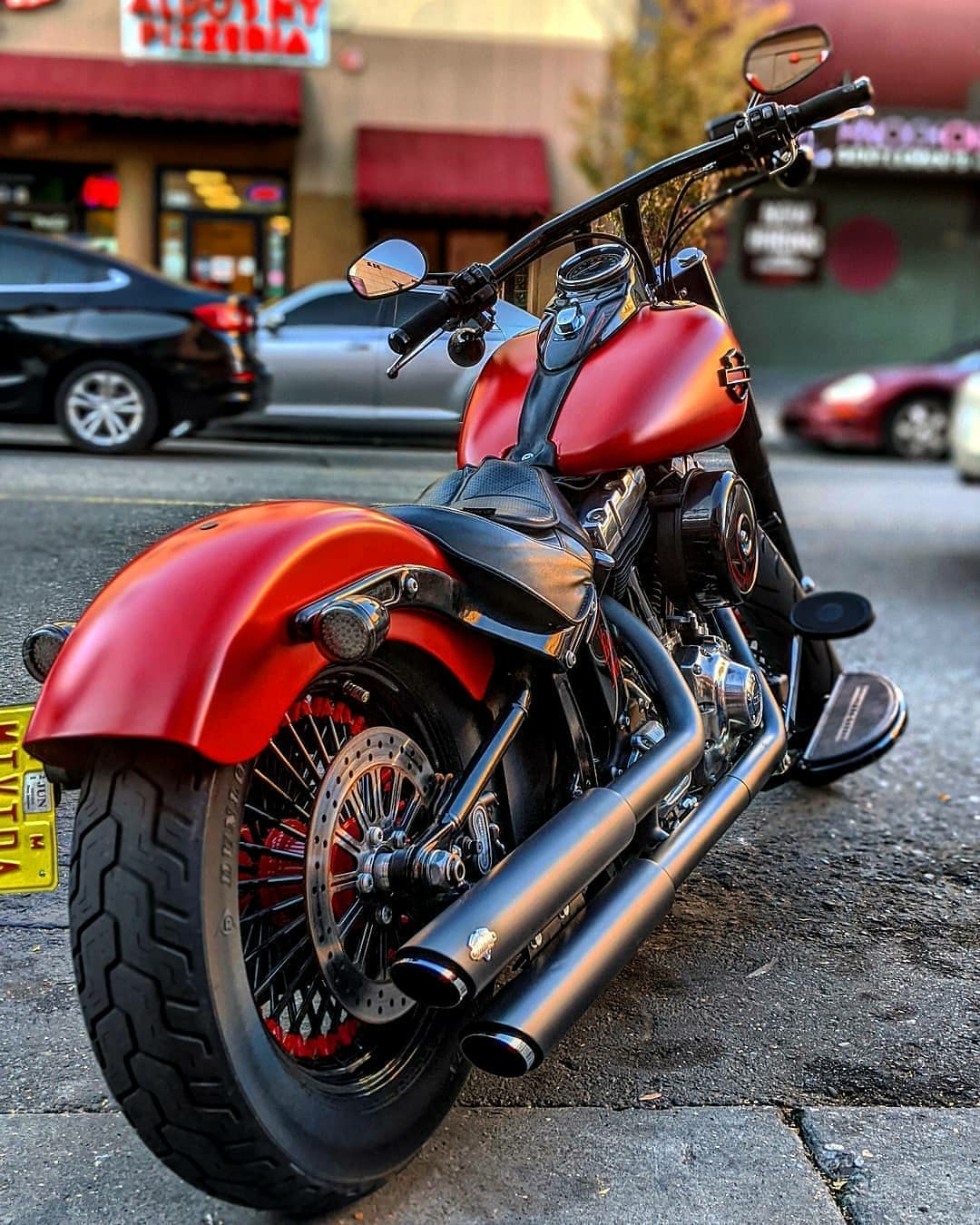 red harley parked on street