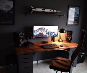 the manly life- manly home office setup with model rocket on shelf