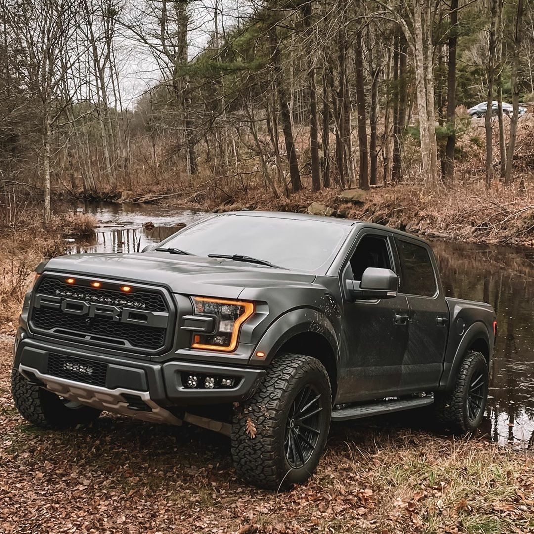 ford raptor truck by a river