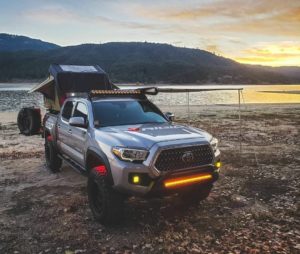 the manly life - tacoma truck camper by lake