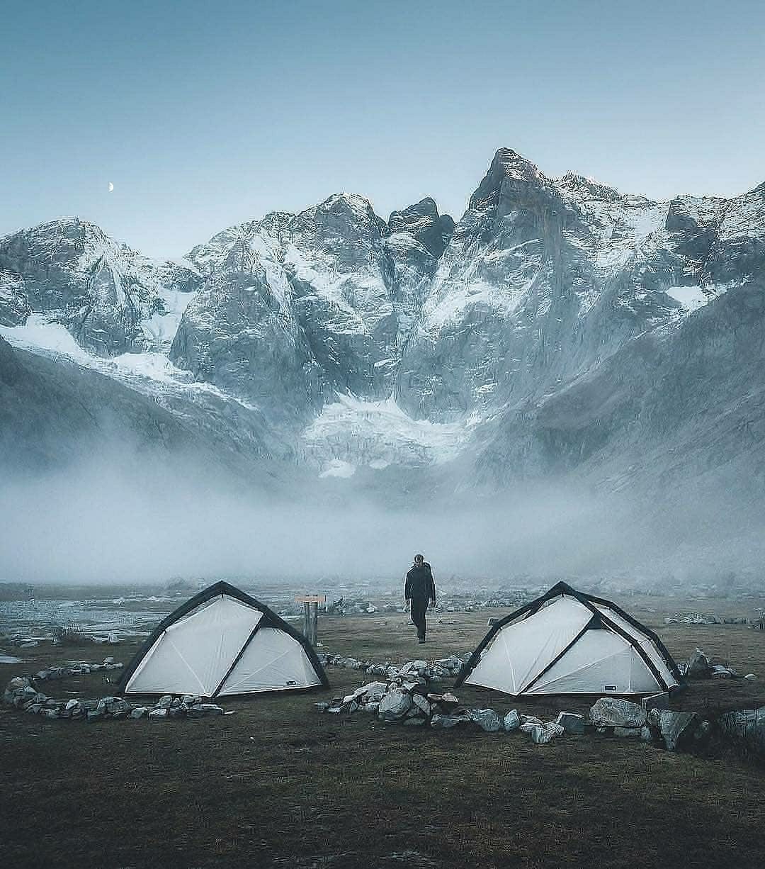 two tents in front of mountains